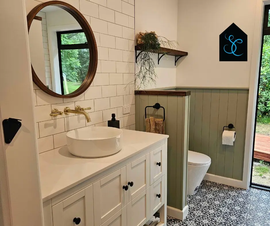 About us, Bright bathroom with modern toilet, vessel sink, and wooden shelving, transformed by Bathrooms Renovations Hamilton.