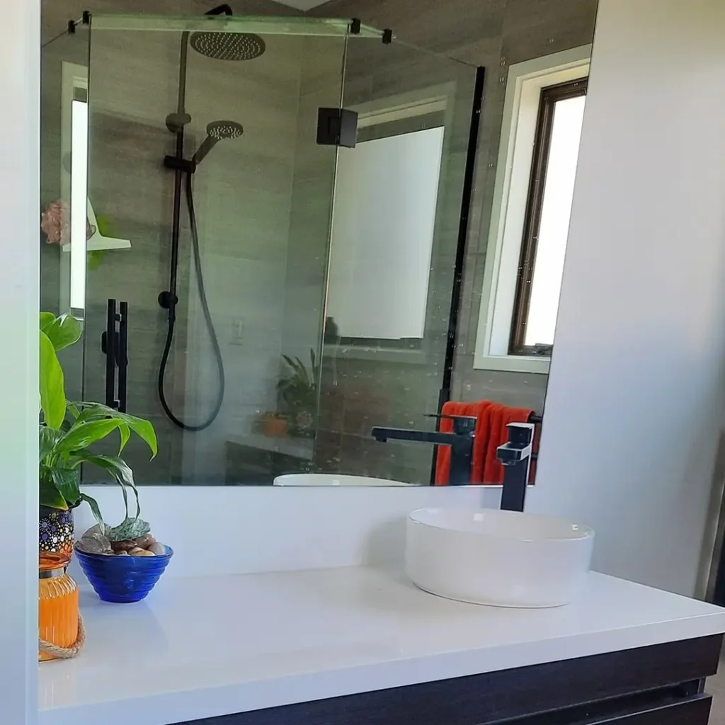 Elegant bathroom design featuring a frameless glass shower and contemporary vanity, crafted by Bathrooms Renovations Hamilton. Contact us