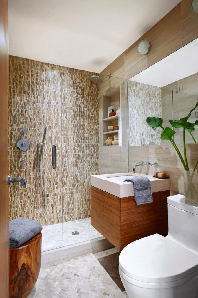 Stylish contemporary bathroom with mosaic shower tiles, a sleek floating vanity, and modern decor designed by Bathrooms Renovations Hamilton.